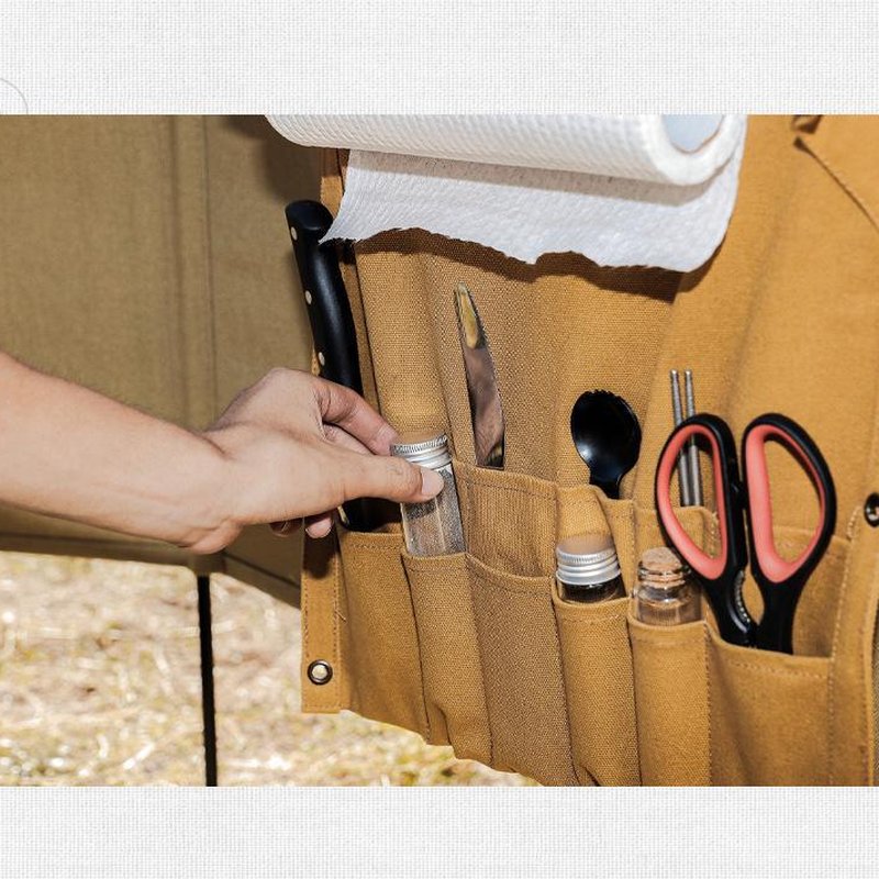 Close-up of the Setstead Hanging Camp Organizer pockets holding scissors, utensils, and spice jars