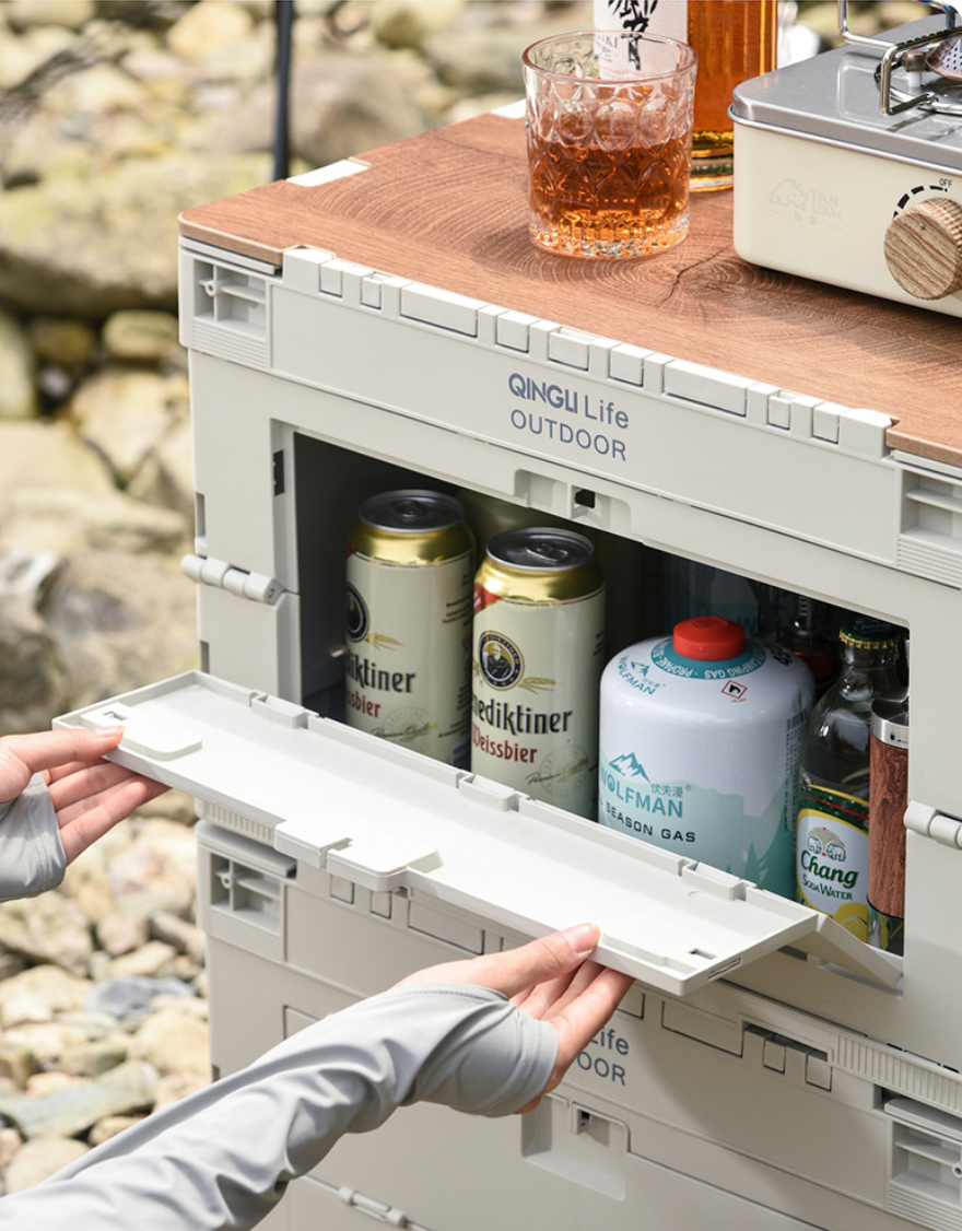Open front door on the Setstead 65L Multifunction Storage Box showing fuel canisters and bottles stored inside