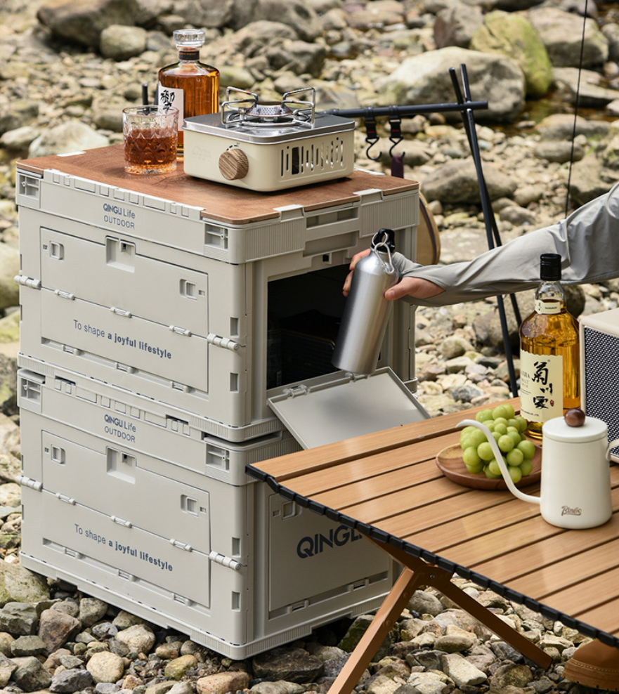 Setstead 65L Multifunction Storage Box used as a camp table with a stove on top and the side door open